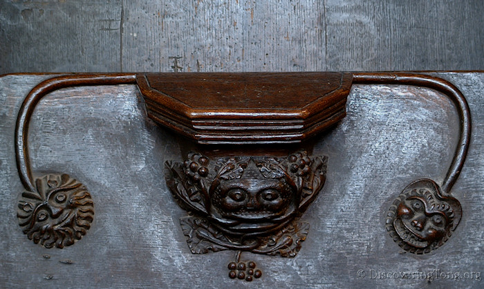 Choir Stall seat bracket showing three faces