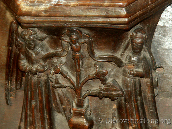 Choir Stall seat bracket showing a lily and crucifix